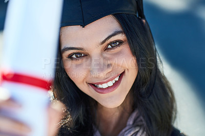 Buy stock photo Portrait of a young graduate holding her diploma on graduation day