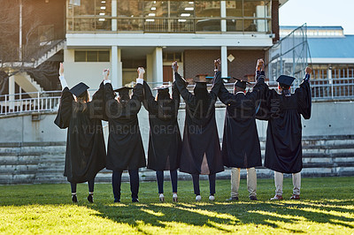 Buy stock photo Holding hands, university and back of friends for graduation, ceremony and academic success. College, diversity and men and women on campus with achievement for education, learning and studying