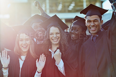Buy stock photo Shot of a group of students standing together on graduation day