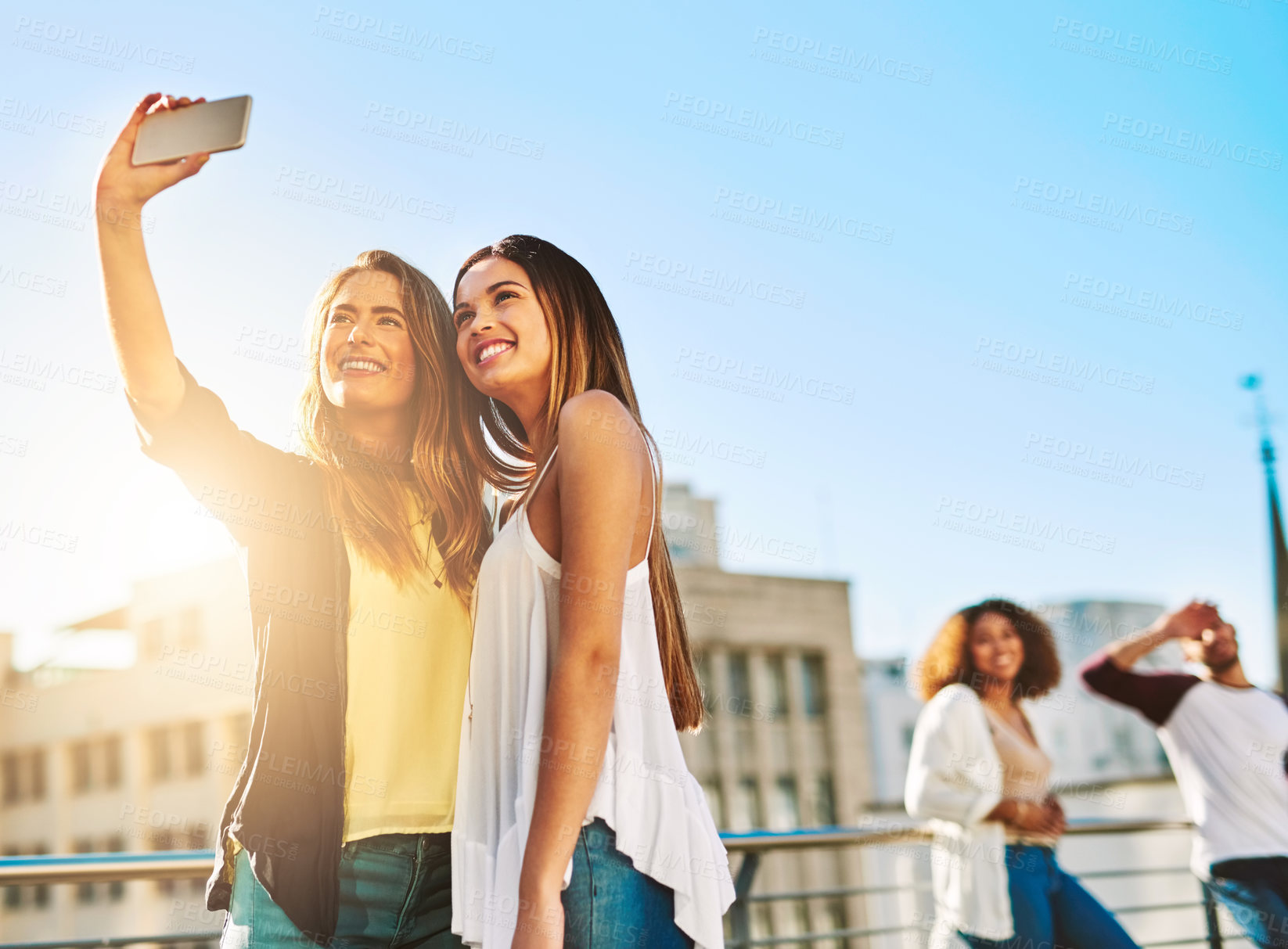 Buy stock photo Shot of young female friends taking a selfie outside