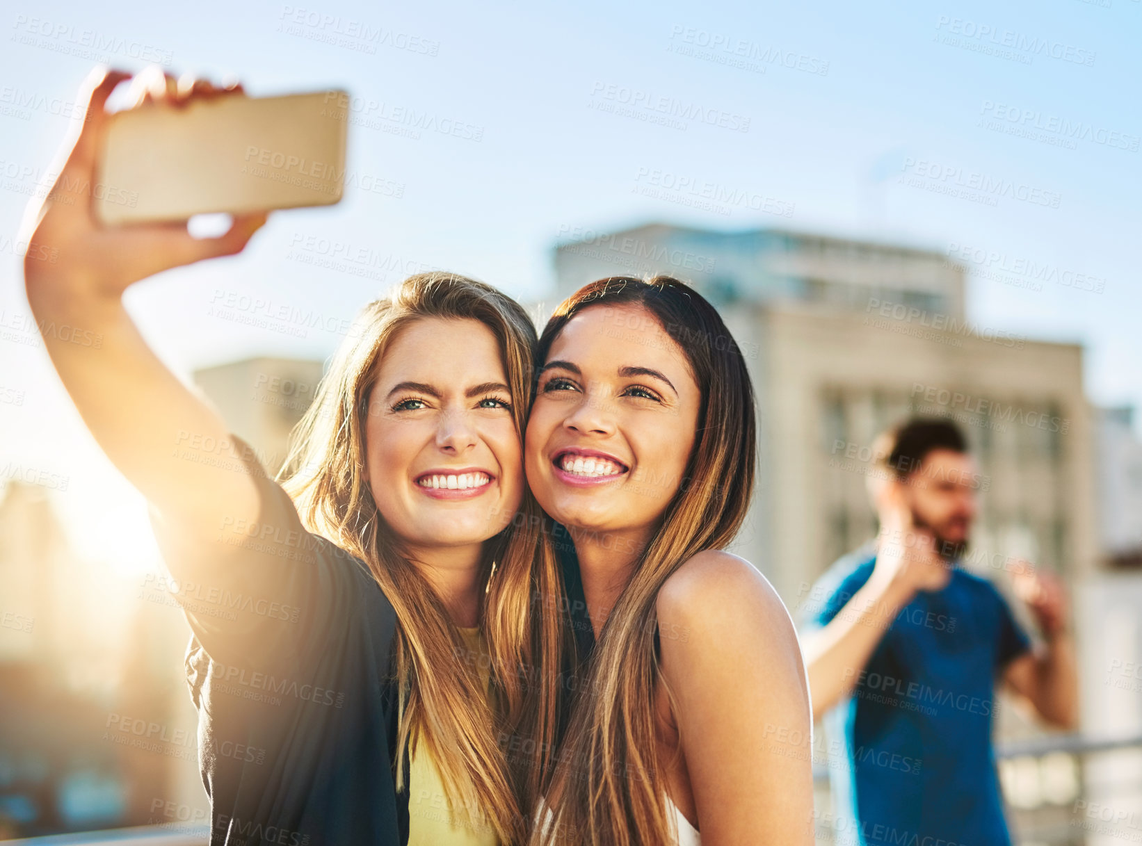 Buy stock photo Shot of young female friends taking a selfie outside