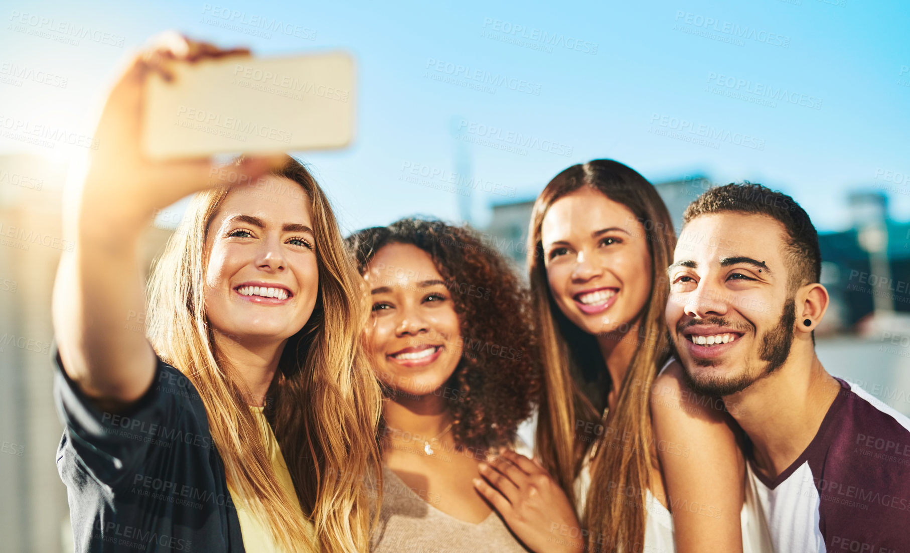 Buy stock photo Shot of young friends taking a selfie outside