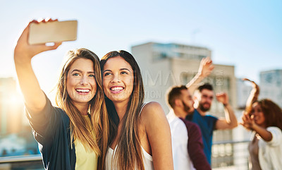 Buy stock photo Shot of young female friends taking a selfie outside