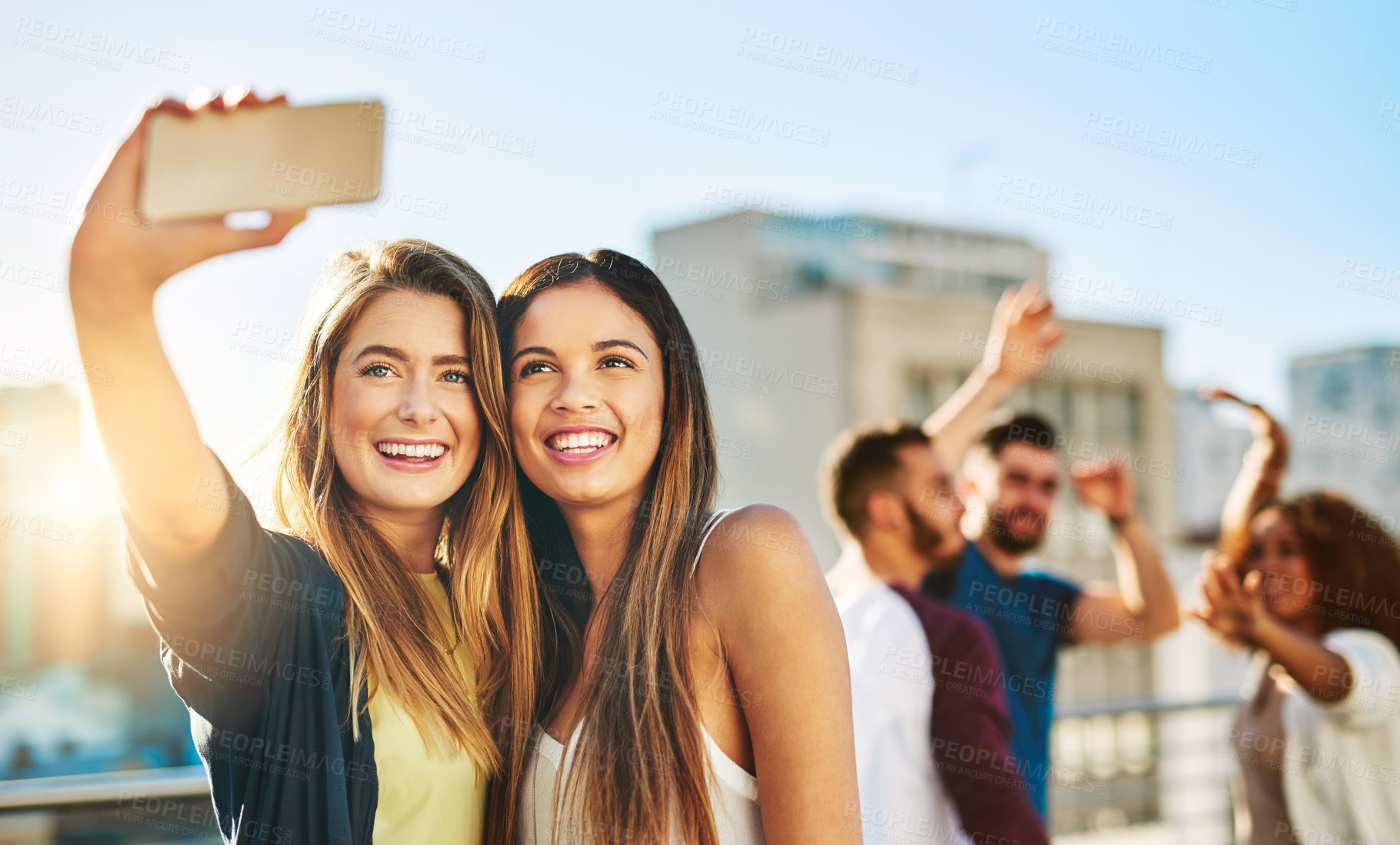 Buy stock photo Shot of young female friends taking a selfie outside