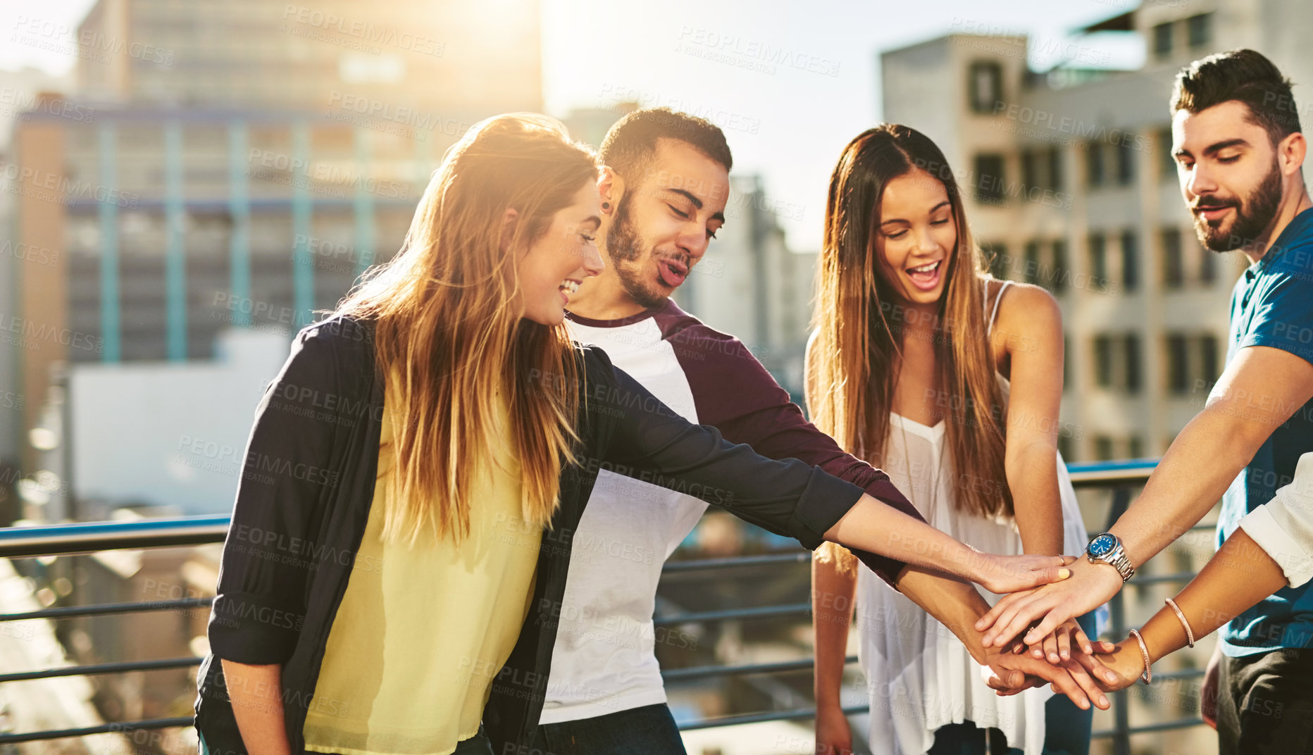 Buy stock photo Cropped shot of a group of young people putting their hands together in unity outside