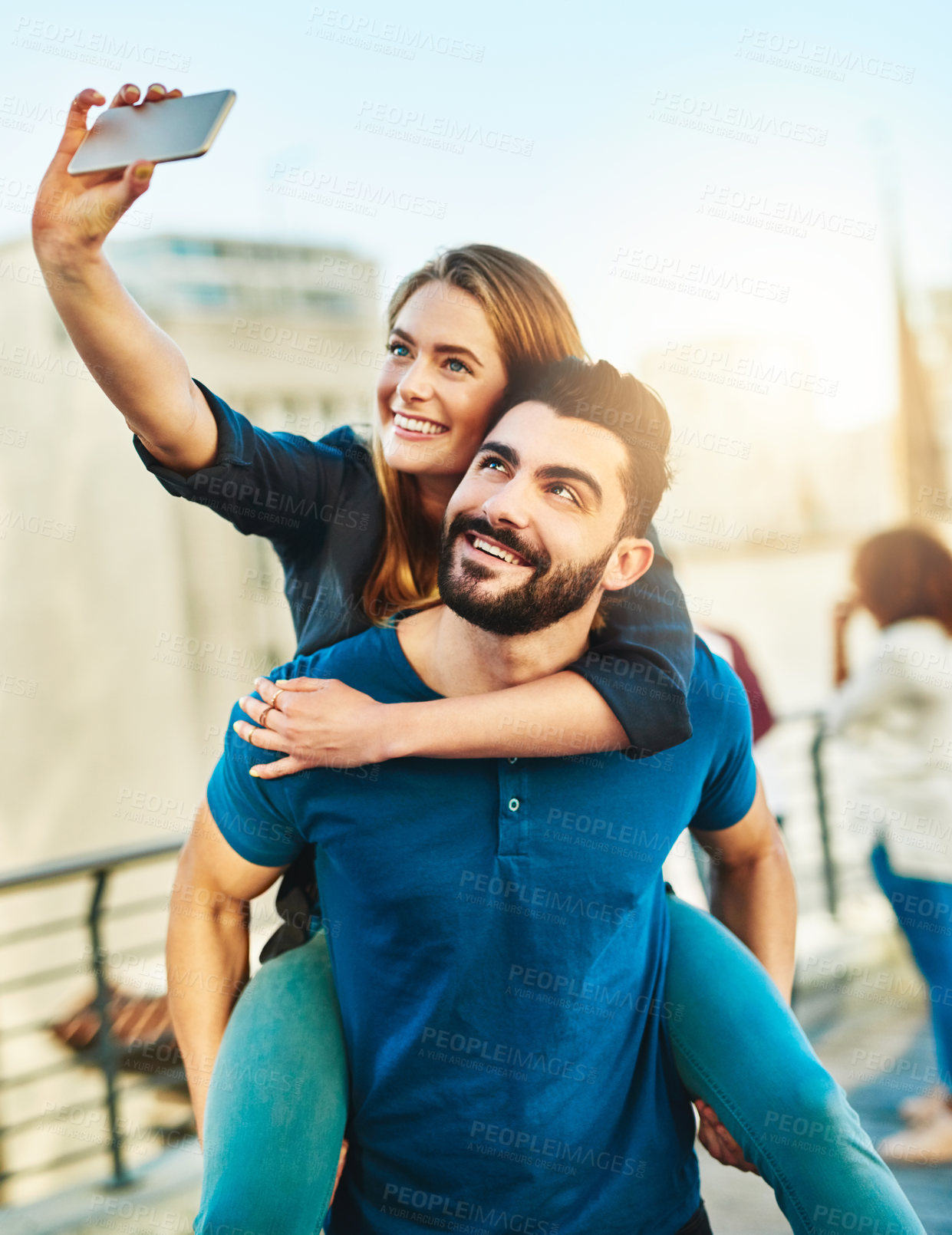 Buy stock photo Shot of a young couple taking a selfie outside