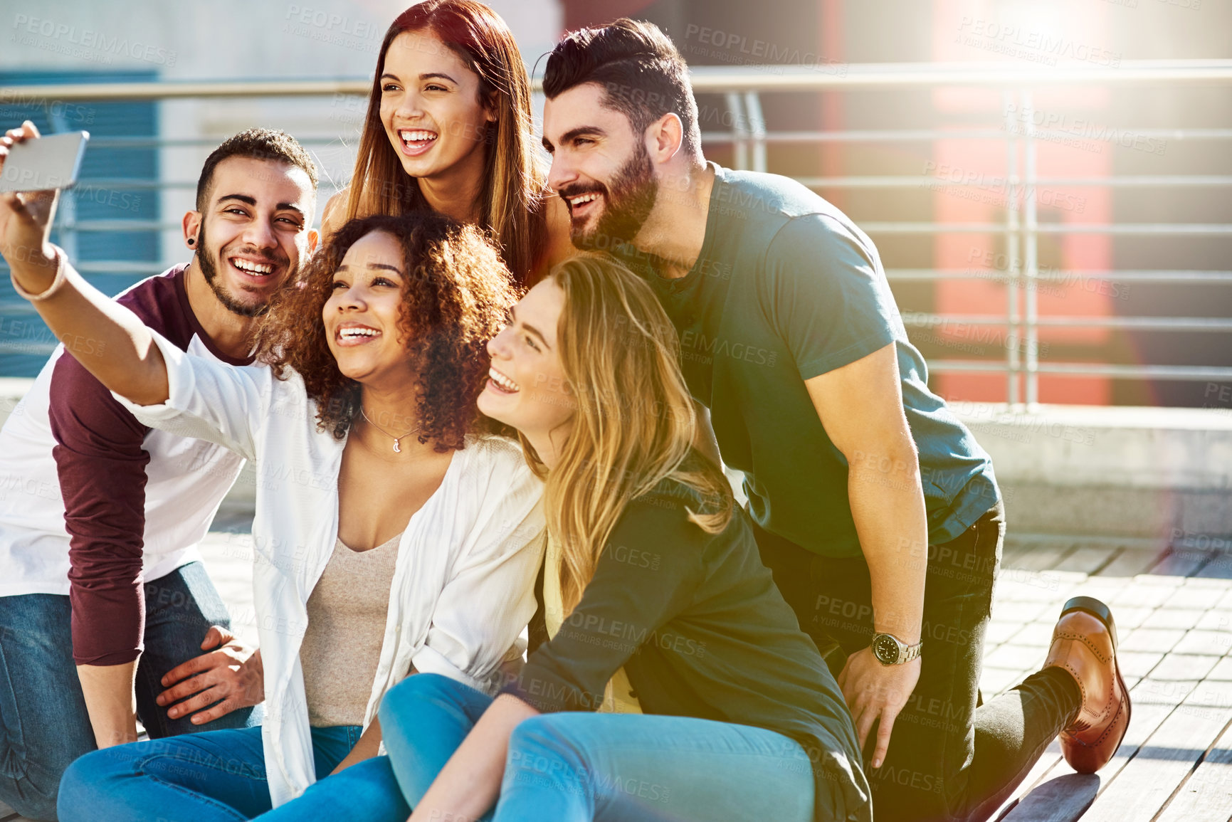 Buy stock photo Shot of young friends taking a selfie outside