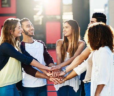 Buy stock photo Cropped shot of a group of people putting their hands together in unity outside
