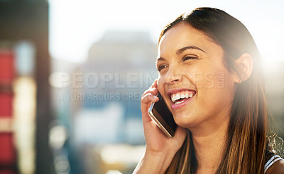 Buy stock photo Shot of a beautiful young woman on a call outside