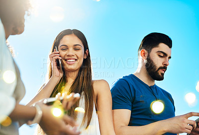 Buy stock photo Shot of a beautiful young woman on a call outside