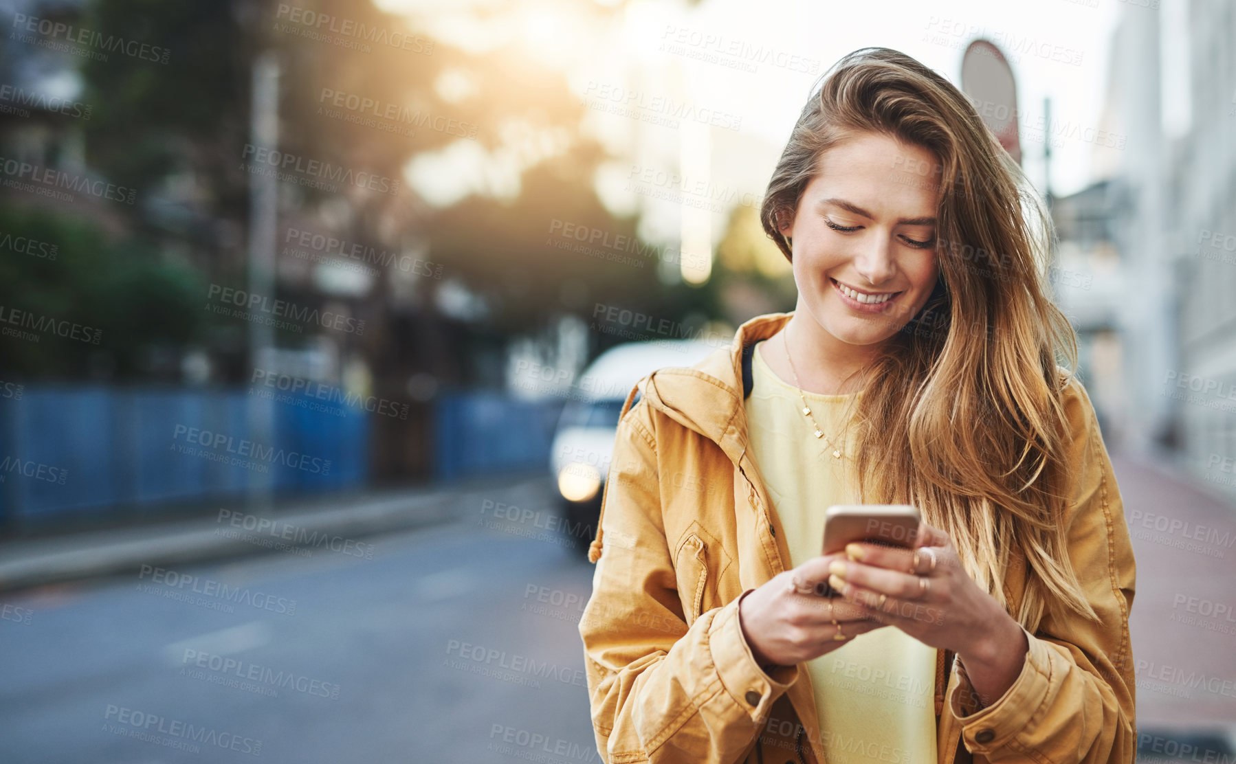 Buy stock photo Woman, smile at smartphone with communication while in city, chat on social media and connectivity outdoor. Happy young person and student in urban street, text contact with mobile app and technology