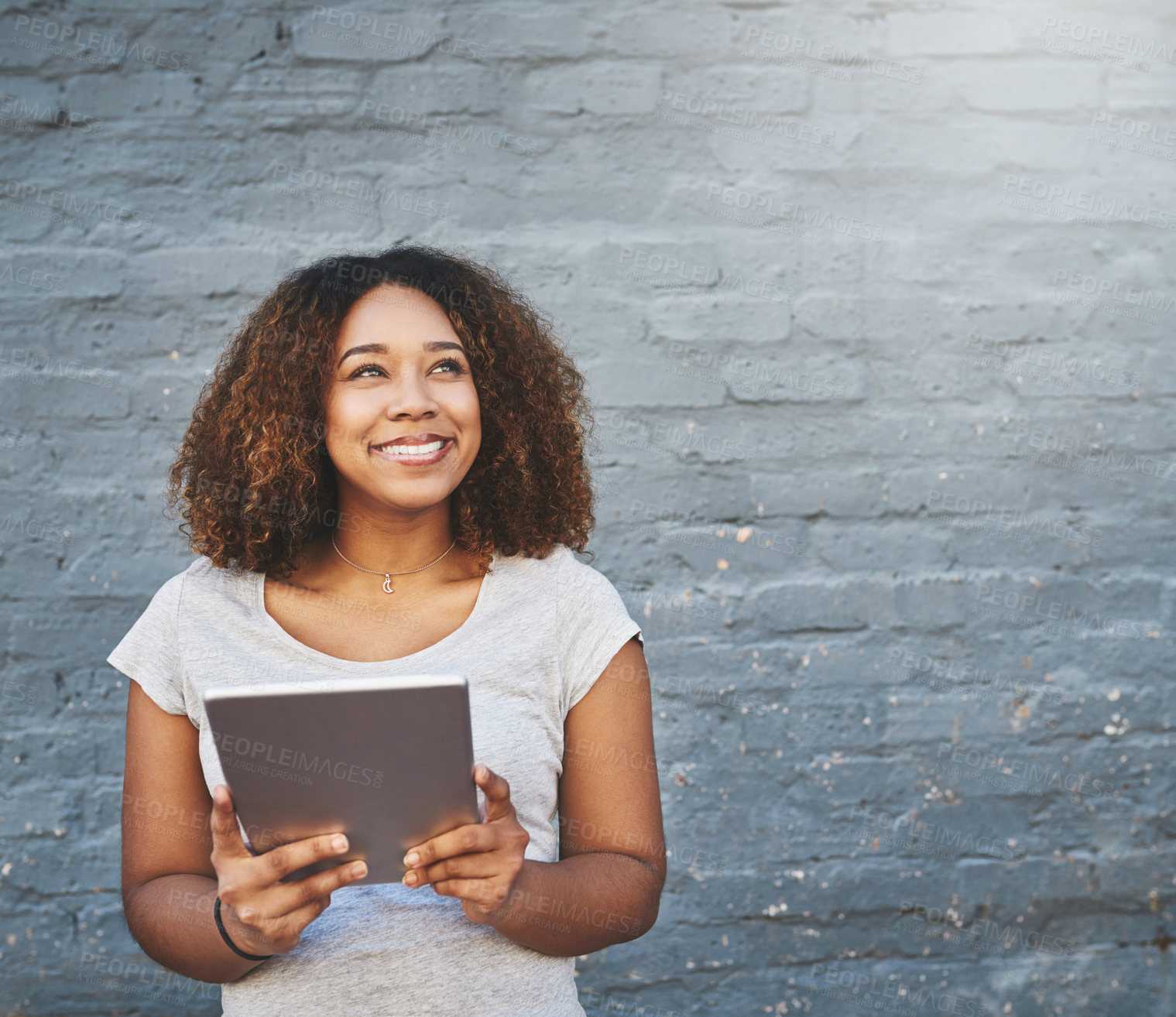 Buy stock photo Smile, tablet and thinking with designer black woman on brick wall background for creative research. Idea, internet, and and technology with happy employee on space for professional web development