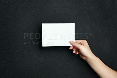 Buy stock photo Hand, studio and blank paper with mockup space for sale, promotion offer or information about us. Closeup, signage or person with placard for news, announcement or logo advertising on dark background