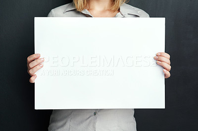 Buy stock photo Studio, woman and hands with paper for advertising poster, design or marketing info on mockup. Female person, banner and plank board with space for news, promotion and branding on black background