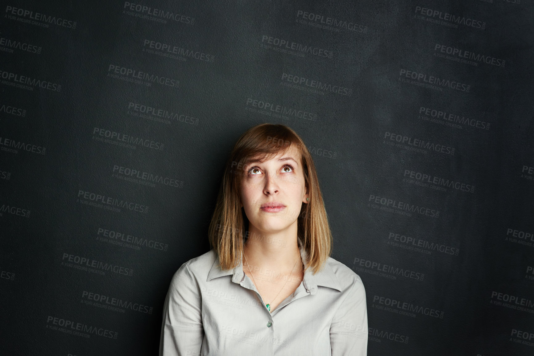 Buy stock photo Chalkboard, space and thinking with woman teacher on black background in classroom for education. Idea, mockup and school with young educator in class for development or learning on blackboard