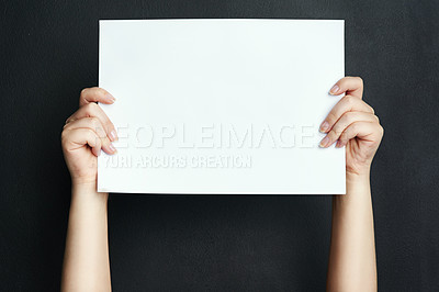 Buy stock photo Studio shot of an unrecognisable woman holding a blank board against a black background