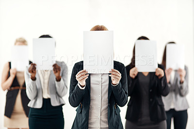 Buy stock photo Businesswoman, staff and holding message on board in studio for anonymous interview of career. Professional, group and female people with blank paper hiding face for marketing as brand ambassador