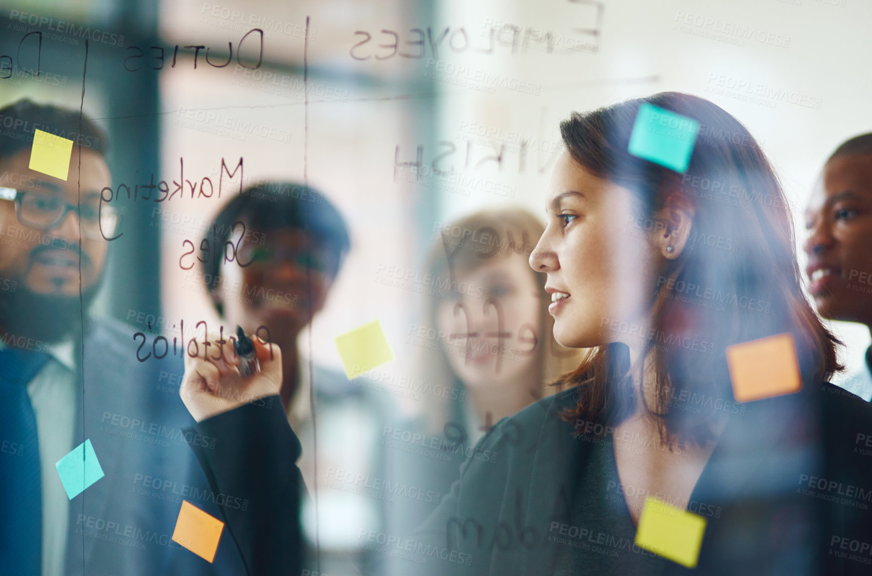 Buy stock photo Business people, glass wall and woman writing, brainstorming and strategy in office. Sticky notes, planning and group of employees working on ideas, schedule and collaboration for teamwork at work.