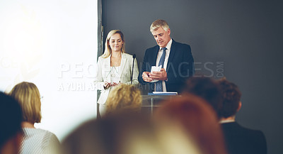Buy stock photo Cropped shot of two corporate businesspeople reading out the names of recipients during a ceremony