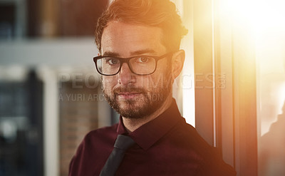 Buy stock photo Portrait of a confident young businessman standing in a modern office