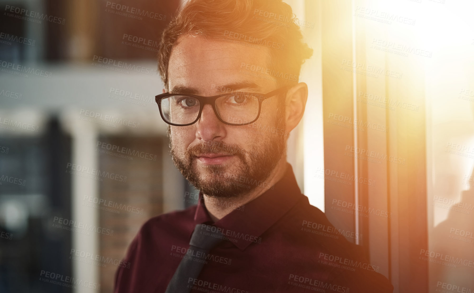 Buy stock photo Portrait of a confident young businessman standing in a modern office