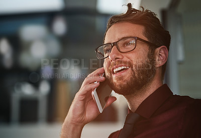 Buy stock photo Shot of a young businessman using a mobile phone in a modern office