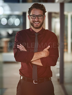 Buy stock photo Portrait of a confident young businessman standing in a modern office