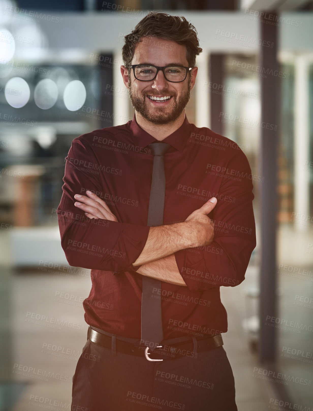 Buy stock photo Portrait of a confident young businessman standing in a modern office