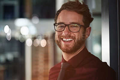 Buy stock photo Portrait of a confident young businessman standing in a modern office