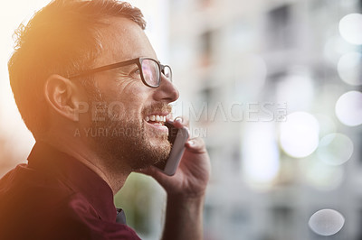 Buy stock photo Shot of a young businessman using a mobile phone outside