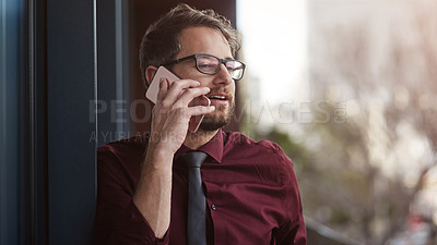 Buy stock photo Shot of a young businessman using a mobile phone on the balcony of an office
