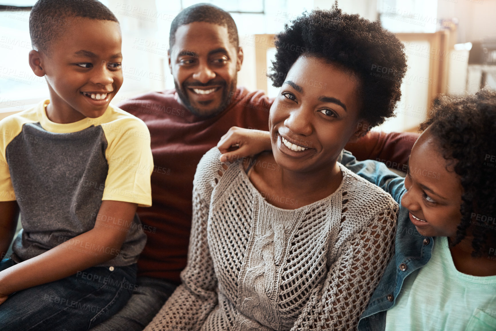 Buy stock photo Black family, smile and relax on living room sofa for happy bonding or quality time together at home. African American mother, father and children relaxing and smiling for family holiday on the couch