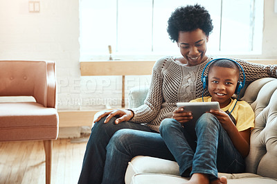 Buy stock photo Mother, child and tablet for watching entertainment, movie or elearning on living room sofa together at home. Happy black mom relaxing with son on couch with touchscreen enjoying wifi, games or music