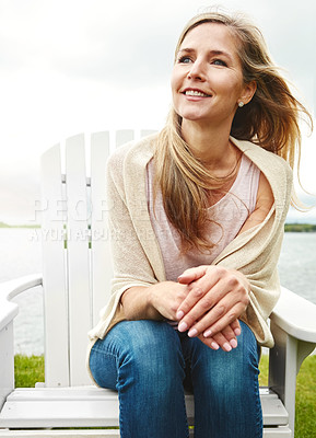 Buy stock photo Female person, peace and wind outdoor for holiday, travel and mindfulness by lake with happiness. Mature woman, calm and breeze in nature for vacation, summer and wellness by pond with smile or hope