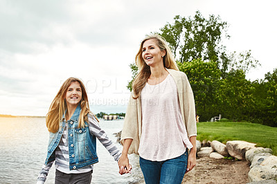 Buy stock photo Holding hands, lake or walking with mother and girl child outdoor in nature together for bonding. Family, love or summer with woman and daughter by water in park for security, support or trust