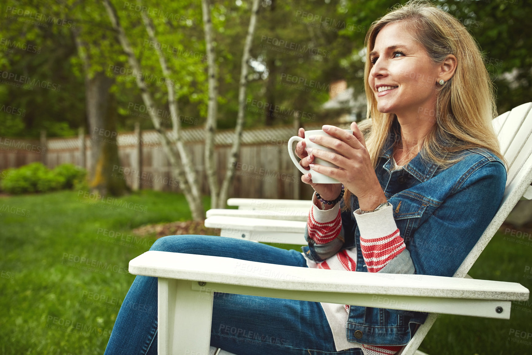 Buy stock photo Coffee, happy and woman relaxing in nature for calm, peace and break on weekend evening. Smile, home and mature female person on outdoor chair drink cappuccino, latte or espresso in backyard garden.