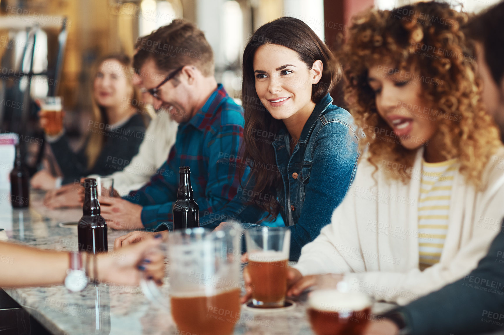 Buy stock photo Shot of people enjoying a drink at a bar