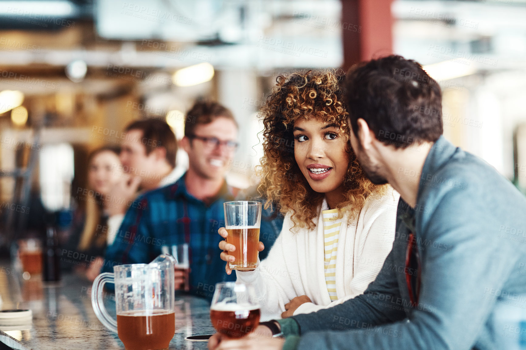 Buy stock photo Shot of a couple enjoying a drink at a bar