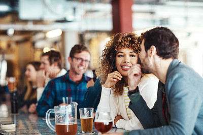 Buy stock photo Shot of a couple enjoying a drink at a bar