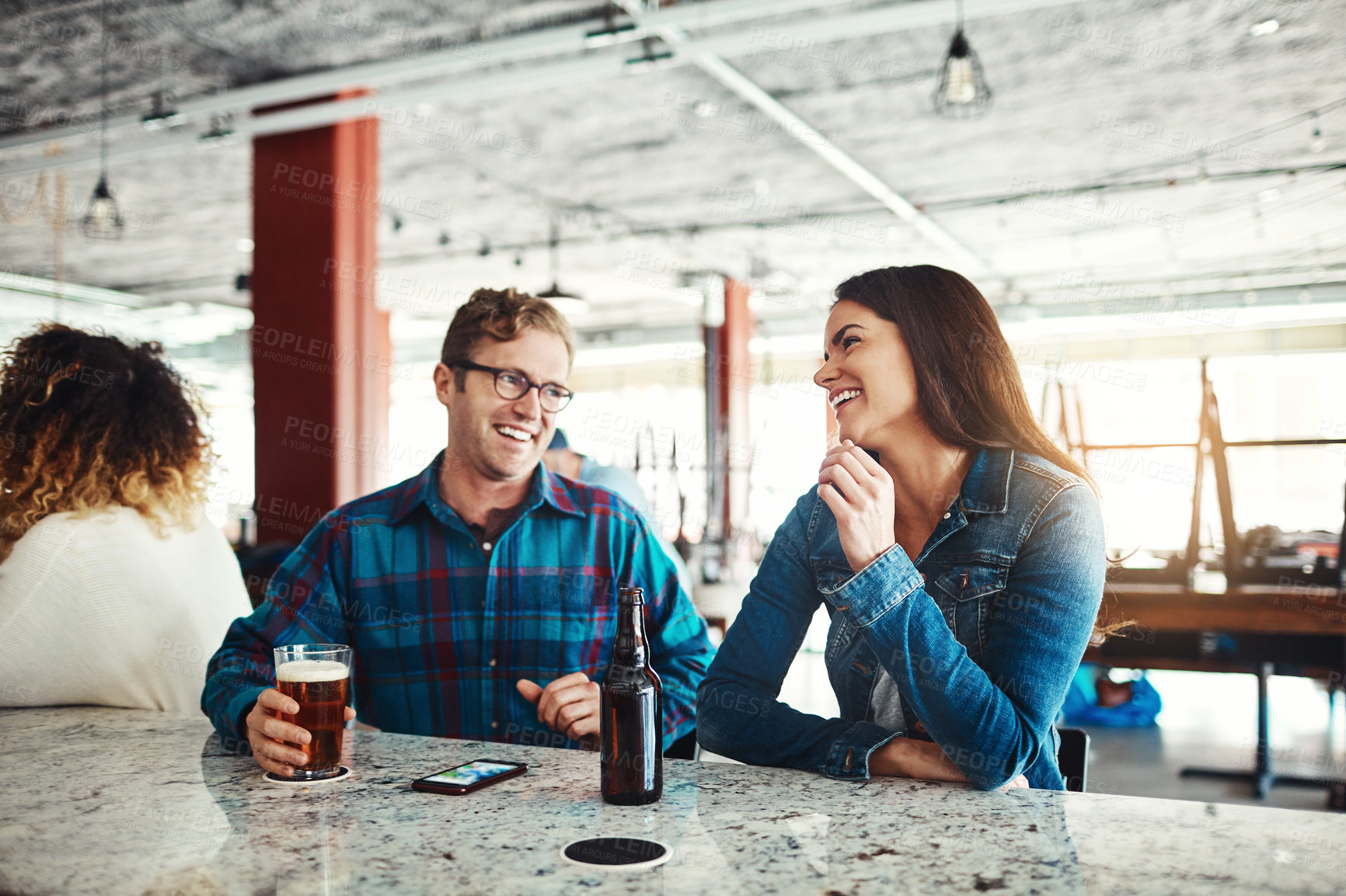 Buy stock photo Shot of a couple enjoying a drink at a bar