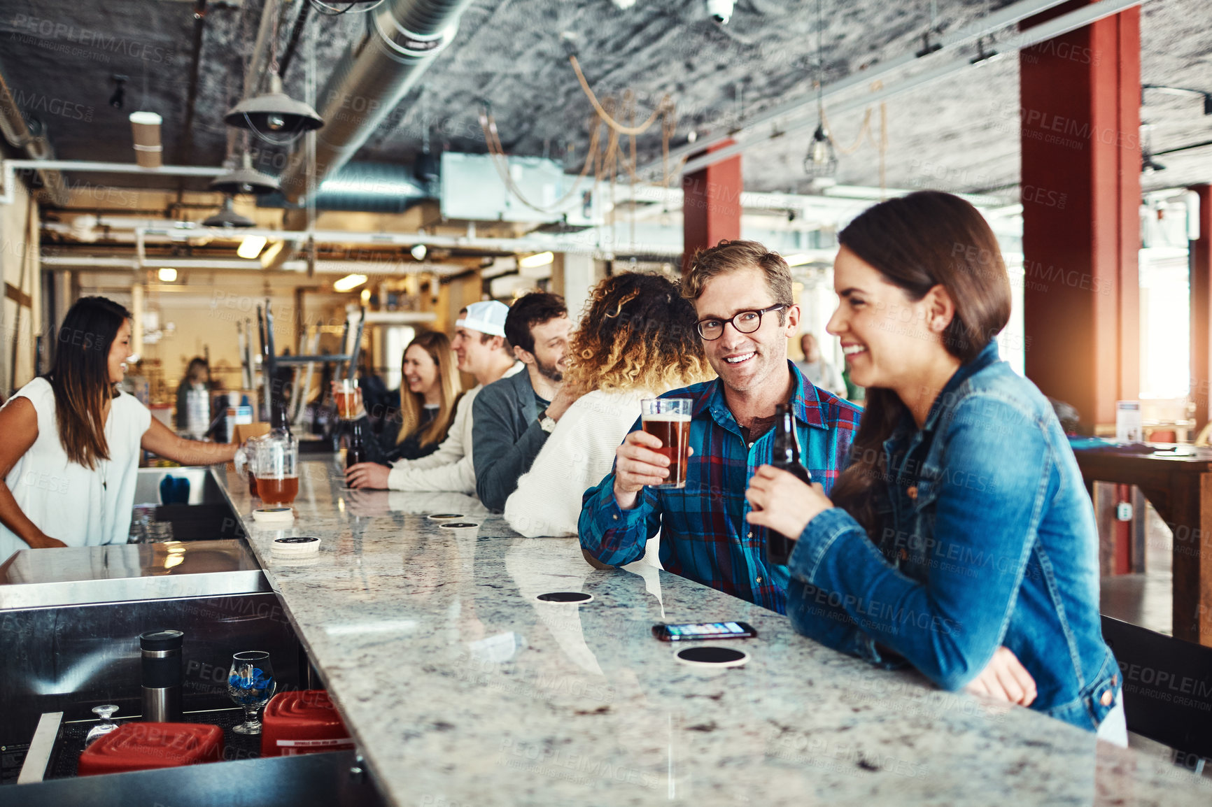 Buy stock photo Shot of a couple enjoying a drink at a bar