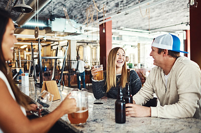 Buy stock photo Shot of a couple enjoying a drink at a bar