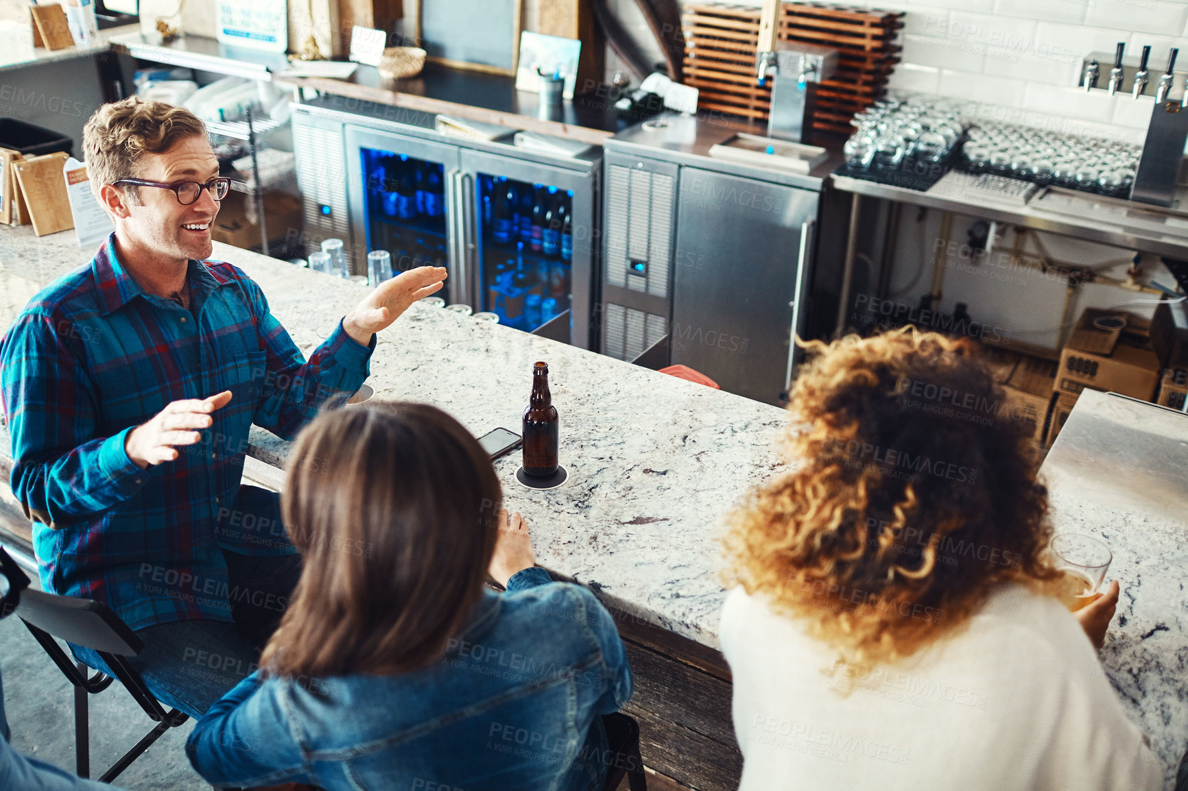 Buy stock photo Shot of people enjoying a drink at a bar