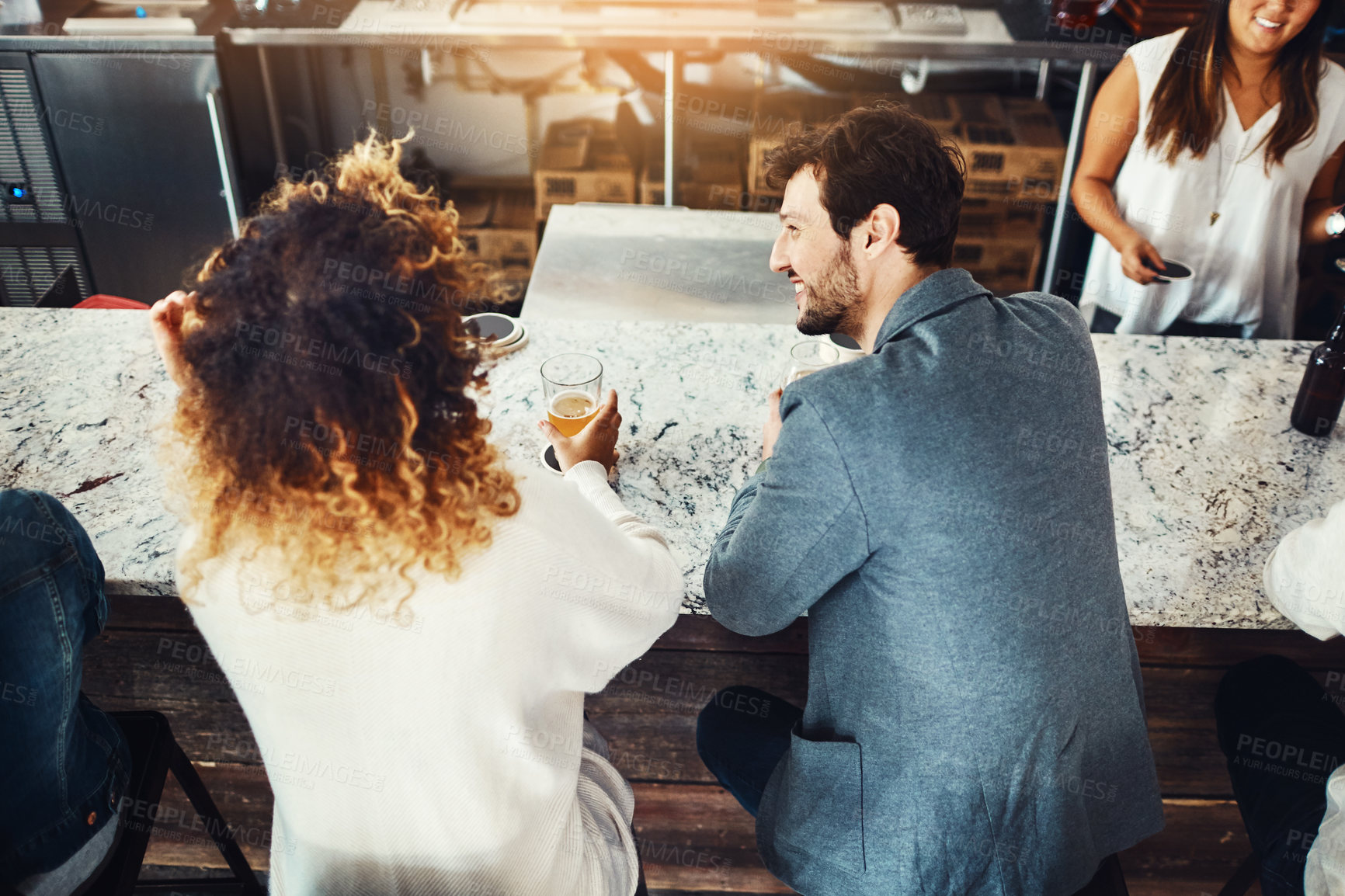 Buy stock photo Shot of a couple enjoying a drink at a bar