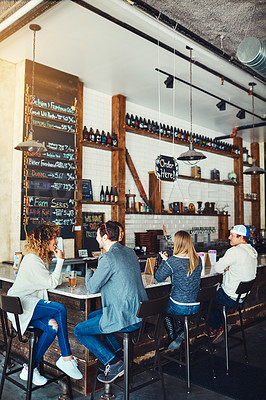 Buy stock photo Shot of people enjoying a drink at a bar
