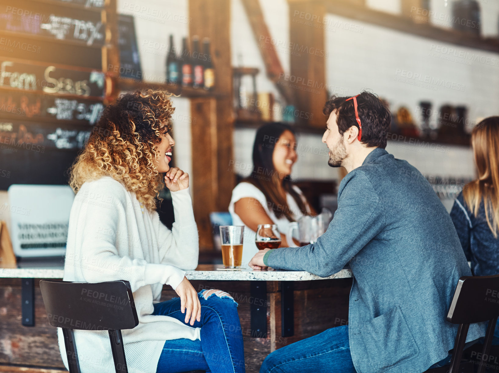 Buy stock photo Shot of a couple enjoying a drink at a bar