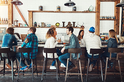 Buy stock photo Shot of young people enjoying a drink at a bar