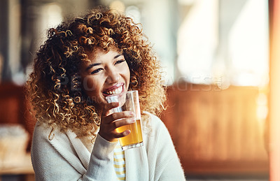 Buy stock photo Shot of a young woman enjoying a drink at a bar 