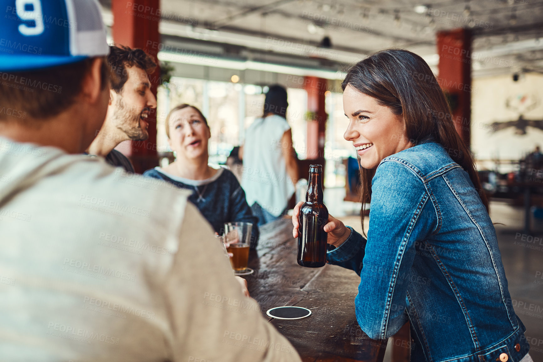 Buy stock photo Shot of a group of friends enjoying some beers at a bar