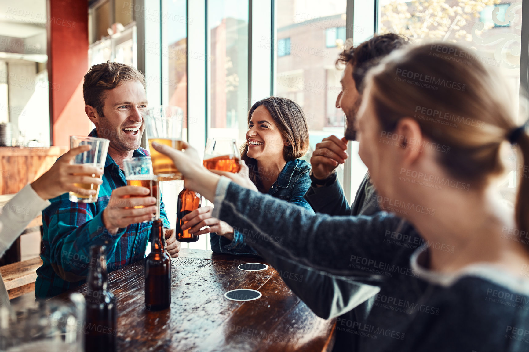 Buy stock photo Friends, people and happy with beer in pub for toast on date at reunion, gathering and fun. Glass, smile and laughing on celebration with bonding, drinking alcohol and together in bar for support